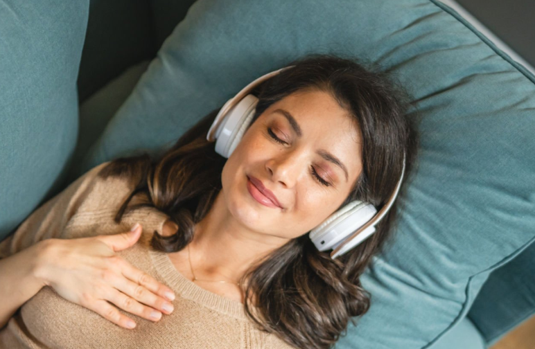 Person relaxing with headphones during an online breathing session