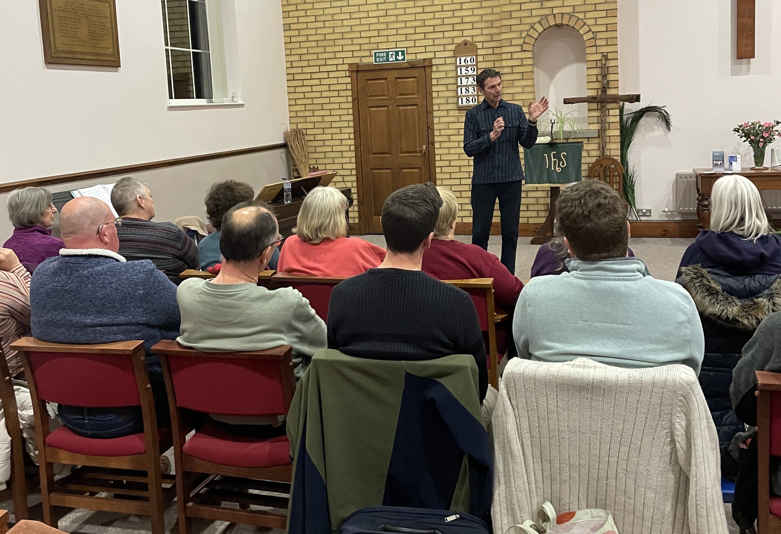 Terry Mellors speaking to a seated community audience